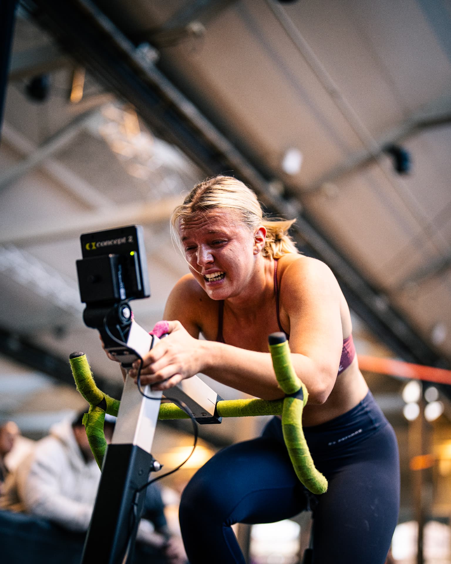 Athlete pushing hard on a Concept 2 bike during competition