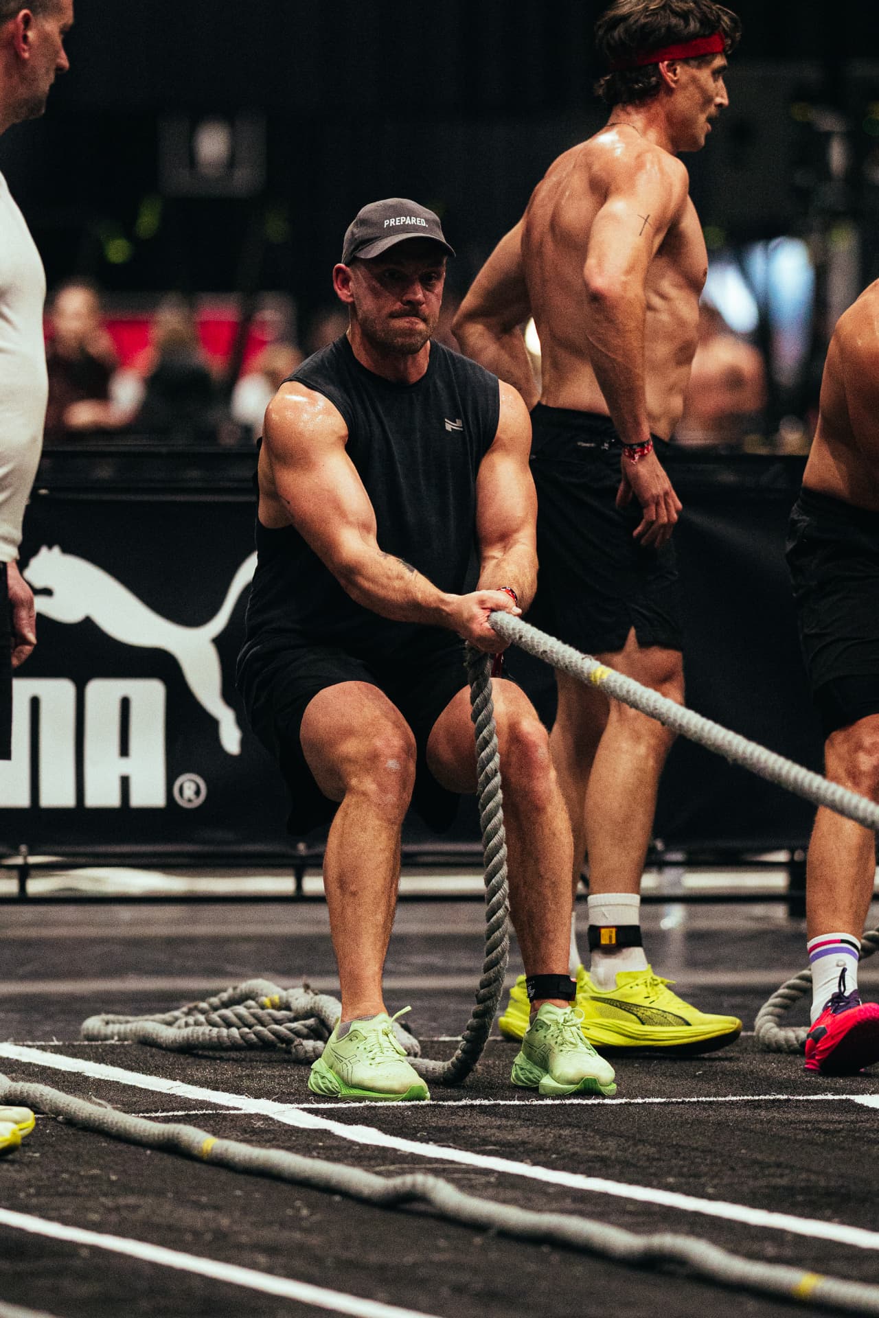 Athlete in a Prepared cap pulling a rope on the competition floor